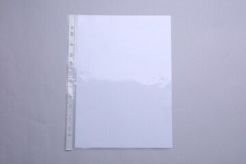 Punched pocket with paper sheet on light grey background, top view