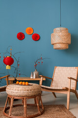 Interior of living room with armchair, table and decor for Chinese New Year celebration