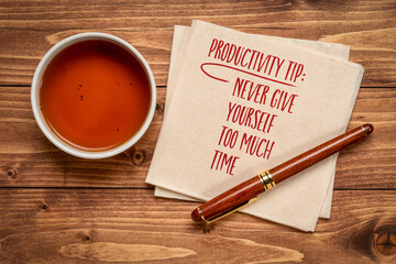 productivity tip, never give yourself too much time - inspirational advice or reminder, handwriting on a napkin with a cup of tea