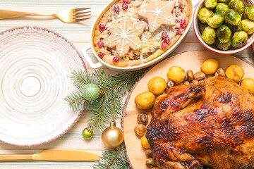 Christmas table setting with tasty food and fir branches on striped cloth, top view