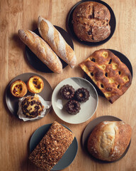Assorted breads on wooden background. French pastries and breads.