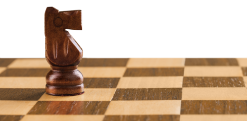 Wooden chess figures on a classic chessboard