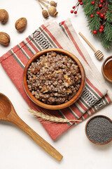 Napkin with bowl of Kutya and ingredients on white background
