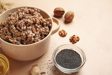 Cooking pot of Kutya and ingredients on beige background, closeup