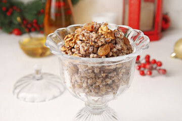 Glass bowl of Kutya on white table, closeup