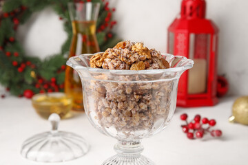 Glass bowl of Kutya on white table, closeup