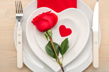 Table setting for Valentine's Day with rose and heart on wooden background, closeup