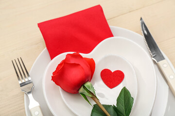 Fototapeta na wymiar Table setting for Valentine's Day with rose and heart on wooden background, closeup
