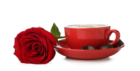 Cup of latte with chocolate candies and rose on white background. Valentine's Day celebration