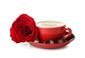 Cup of latte with chocolate candies and rose on white background. Valentine's Day celebration