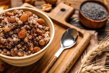 Bowl of Kutya on wooden board, closeup