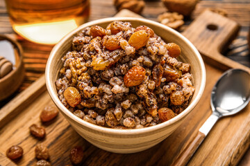 Bowl of Kutya on wooden board, closeup