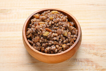 Bowl of Kutya on wooden background