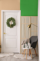Interior of living room with door and Christmas wreath