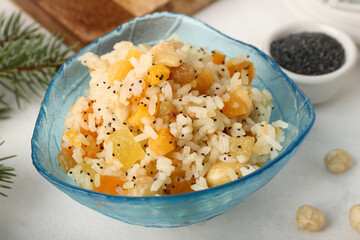 Bowl of rice Kutya on white table, closeup