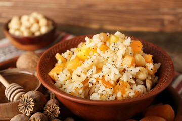 Bowl of rice Kutya, ingredients and poppy pods on tray, closeup