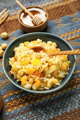 Bowl of rice Kutya with spoon on napkin, closeup