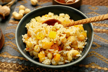 Bowl of rice Kutya with spoon on napkin, closeup