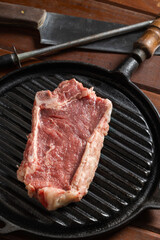 Raw Argentine steak on a griddle.