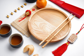 Table setting with Chinese symbols on white background. New Year celebration
