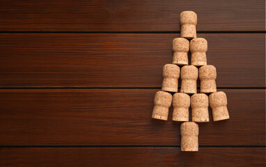 Christmas tree made of wine corks on wooden table, top view. Space for text