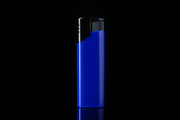 Blue plastic cigarette lighter on black background, closeup