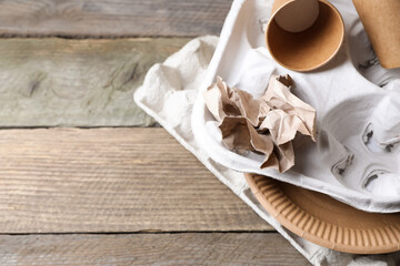 Different waste paper on wooden table, above view. Space for text
