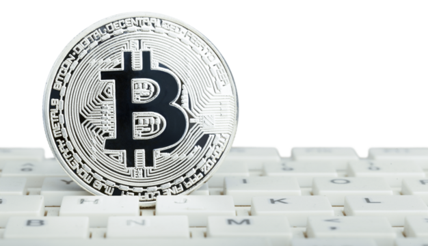 Silver cryptocurrency bitcoin on laptop keyboard