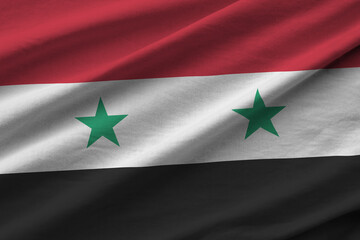 Syria flag with big folds waving close up under the studio light indoors. The official symbols and...