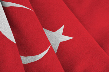 Turkey flag with big folds waving close up under the studio light indoors. The official symbols and...