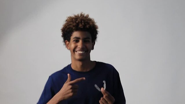 video of a handsome teenager afro latin smiling holding a dentals aligner