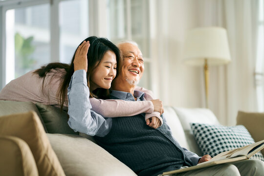 asian elderly father and adult daughter having a good time