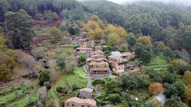 Aerial drone view of Cerdeira xisto schist shale village in Lousa, Portugal, going backwards, close