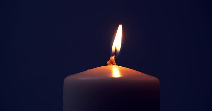 Candle Flame with Alpha Channel. The candle burns with a soft yellow flame. Candlelight, isolated. Close-up, slow motion. Candle lit on transparent background. Life, remembrance, or celebration.