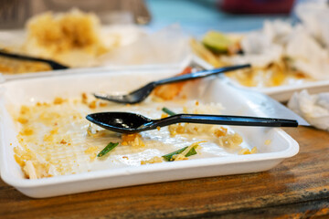 Dirty disposable dishes on the table. Fast lunch at a fast food cafe.