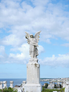 Sculpture of an angel wearing a long robe  under the blue skies