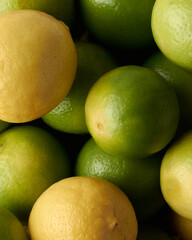pile of lime, high in vitamin c, antioxidant and other nutrients, close-up of sour citrus fruits in full frame background