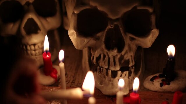 Skull and candlelight at night, religion and belief, magic or ritual