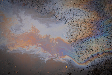 Gasoline stains on asphalt. Gasoline spilled on road.