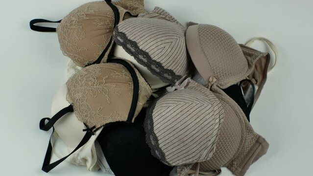 A stack of bras for fashionable women. Underwear for women. The concept of beautiful and comfortable underwear for women. Close-up from above. Flat lay