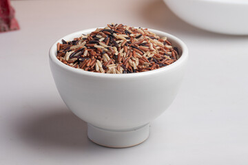 Raw riceberry in white cup.Healthy food.