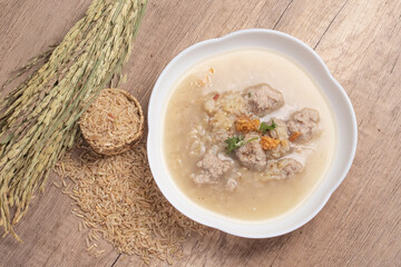Jasmine brown rice porridge with pork on wooden background.Healthy food copy space