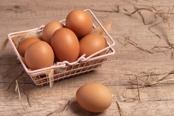 Fresh eggs in a basket on a wooden background.Copy space.