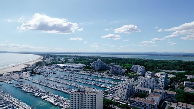 Aerial flight over marina of La grande motte and famous Pyramide Architecture in background