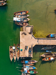 Aerial view of Bo Chet Luk port Harbour with long tail boats, in Satun Geopark, Thailand - obrazy, fototapety, plakaty