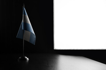 Small national flag of the Argentina on a black background