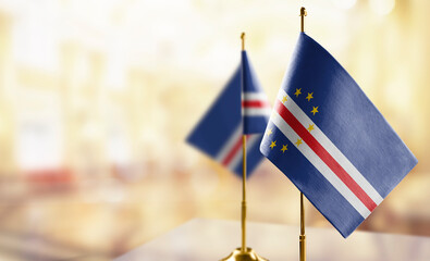 Small flags of the Cape Verde on an abstract blurry background