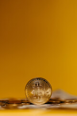 golden bitcoin coin with yellow background