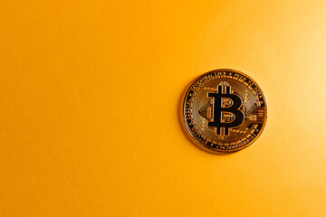 golden bitcoin coin with yellow background