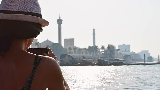 Caucasian tourist on holiday vacation in Dubai have traditional abra boat ride to Dubai creek